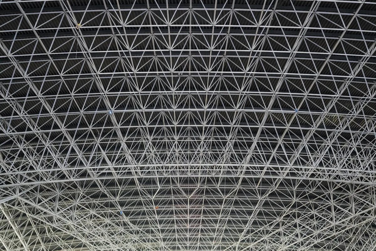 Steel space-frame truss structure (placeholder -- Unsplash)